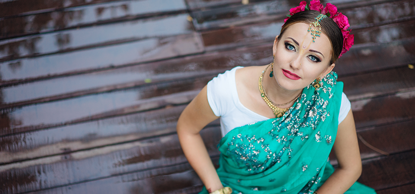 Indian woman with light blue eyes wearing traditional clothing.