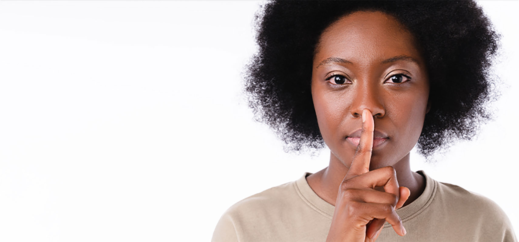 Woman using silence gesture.