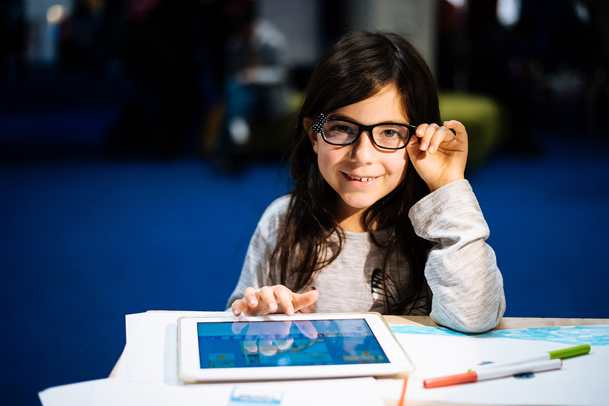 Happy girl engaging in a STEM activity.