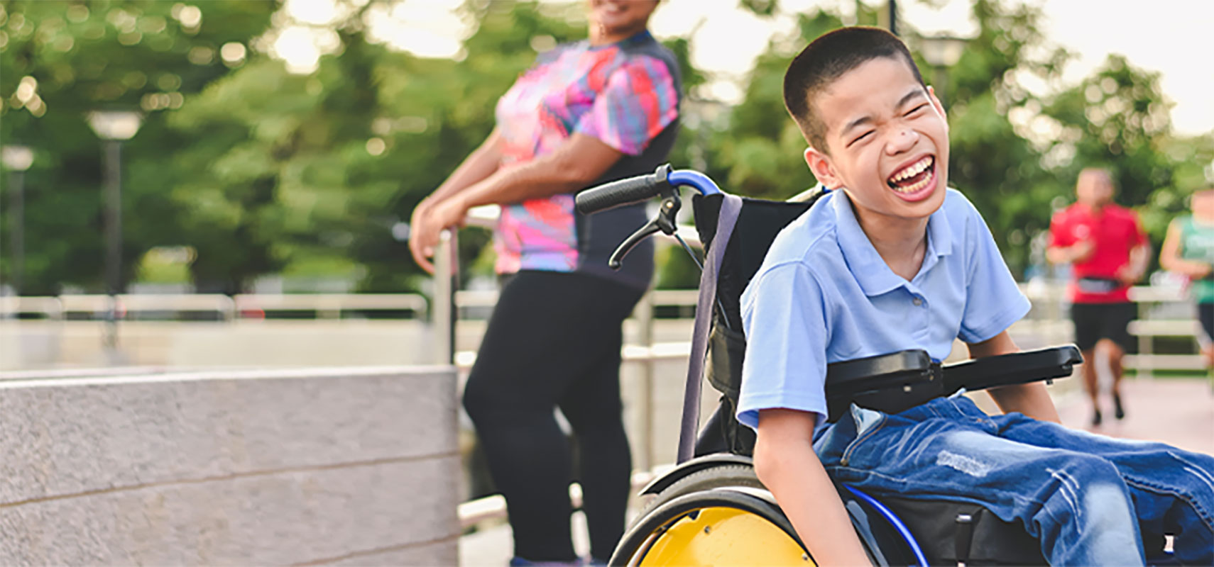 Child in wheelchair outdoors.