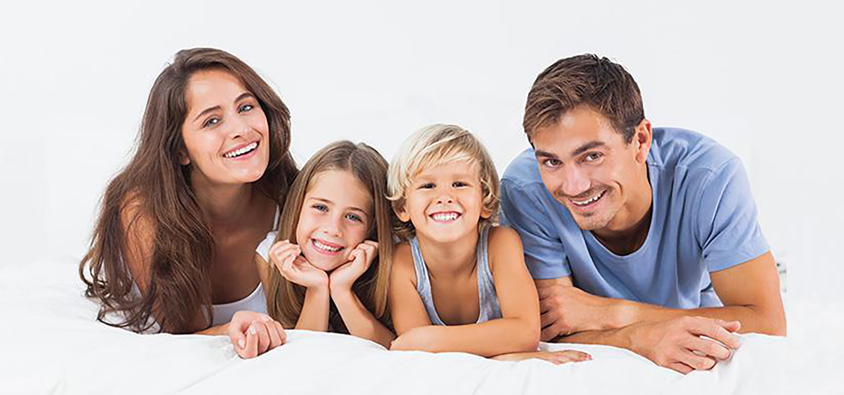 Family smiling while lying down.