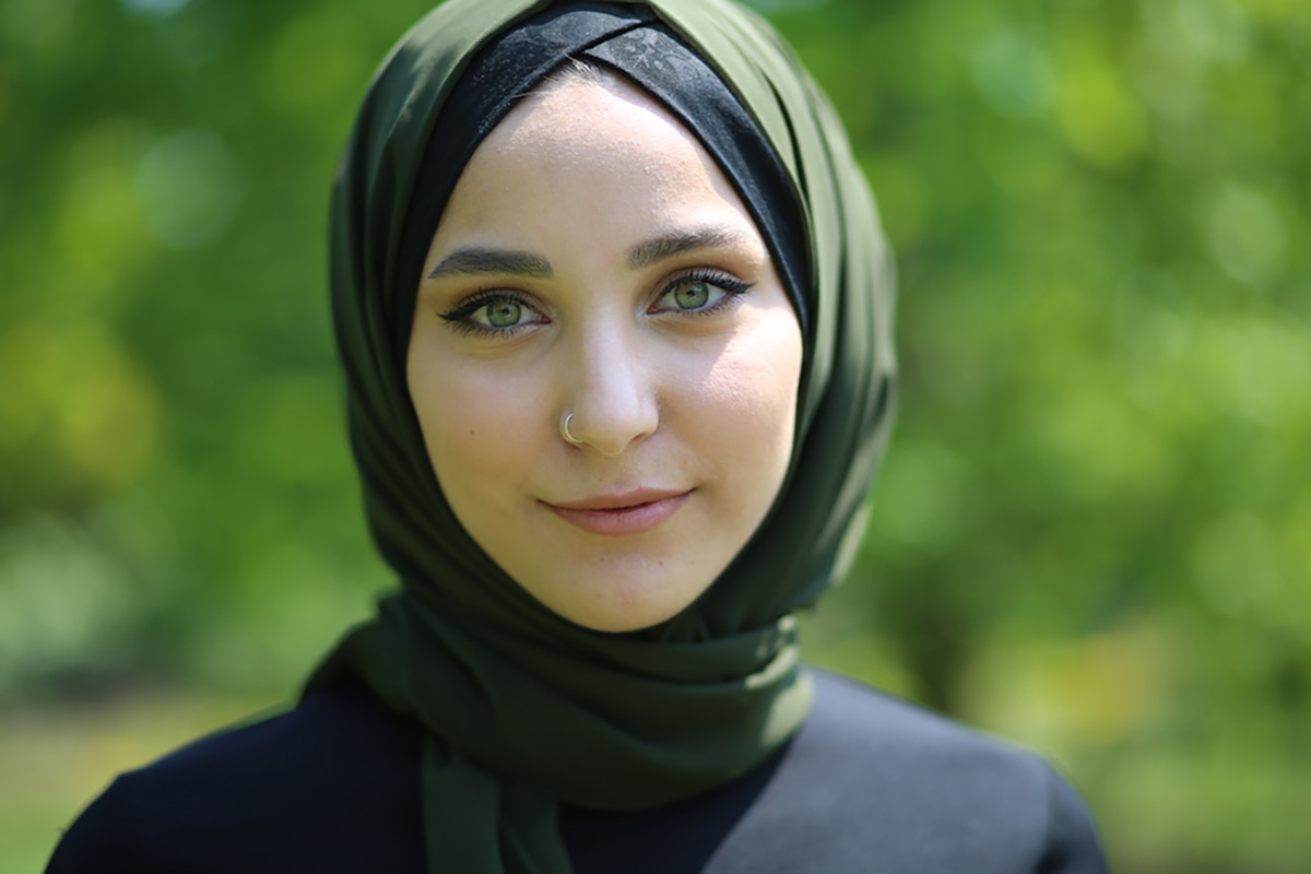 Green-eyed woman wearing a green hijab.